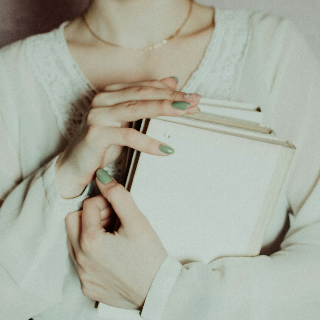 Hands writing personal reflections in a notebook