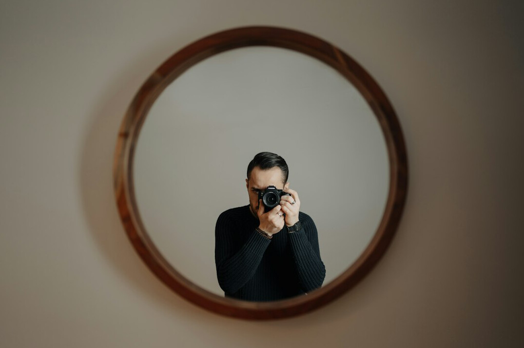 person reflecting in mirror
