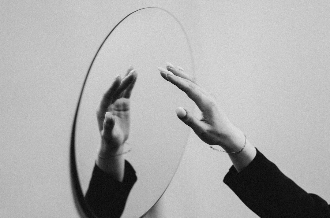 person reflecting in mirror