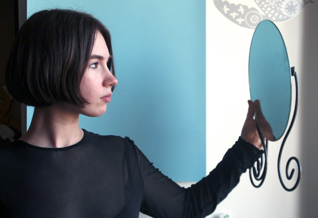 woman practicing speech in mirror